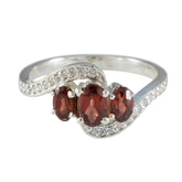Xiu red gemstone trilogy ring with three oval red stones and pave accented sterling silver band